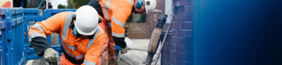 Construction worker digging hole into ground.