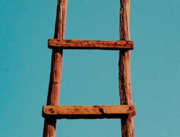A wooden ladder on a blue background