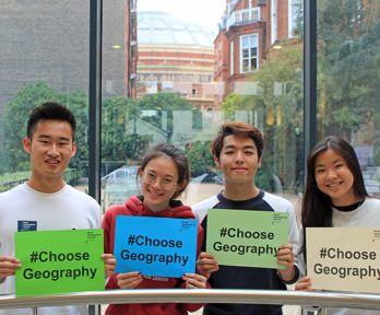 Four young people holding up signs with the text Choose Geography.