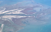 Aerial view of a braided river flowing into the sea.