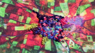 Close up of Lucy Tammam's embroidered scarf. 