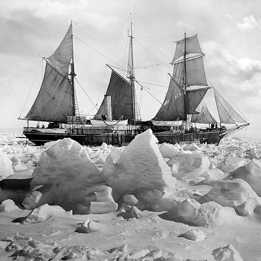 Cropped black and white photograph showing the Endurance ship manouvering through ice floes in the Arctics.