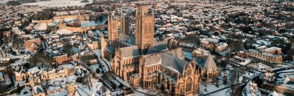 Aerial view of Lincoln Cathedral and city with snow covered ground and buildings