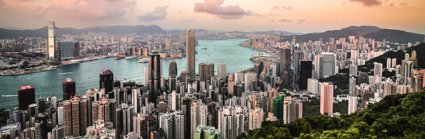 A view over Hong Kong, showing a cityscape, river and woodlands