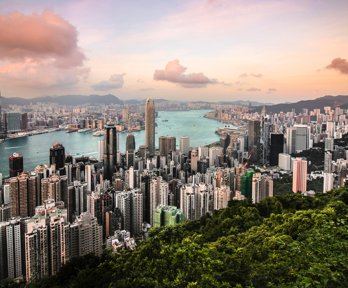 A view over Hong Kong, showing a cityscape, river and woodlands