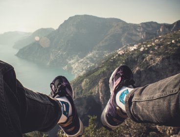 Two feet with a coastal area in the distance