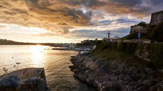 Plymouth City’s coastline under a sunset sky