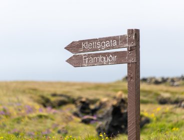 Brown wooden signpost