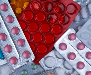 Empty, partially empty and full packs of pills and tablets thrown on top of each other