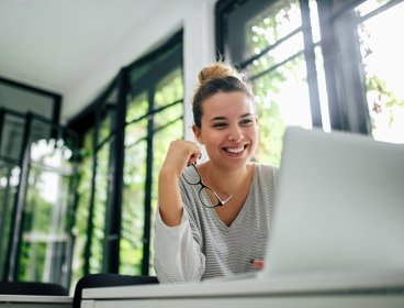 Female watching a lecture recording on their laptop. 