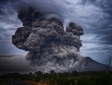 A volcano erupting with a huge ash cloud