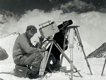 Two photographers sitting on Mount Everest