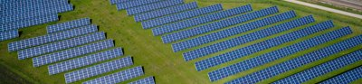 Solar panels in a field, viewed from above