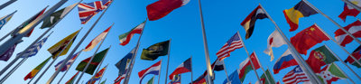 Multiple Flags Flying In Blue Sky