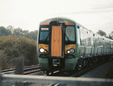 Yellow and green train on tracks.