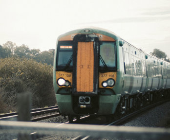 Yellow and green train on tracks.