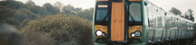 Yellow and green train on tracks.