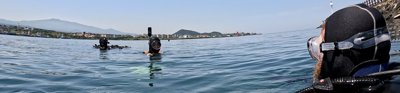 Three divers in the water off Jeju Island with their heads above the water.