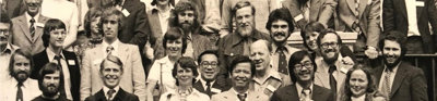 Black and white photograph of group of people stood on the stairs at the Society.