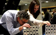 Two people looking at folders of old image films.