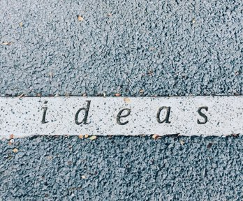 A tarmac floor with the word 'ideas' printed into it