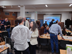 Delegates gather at the Social and Cultural Geography Research Group's 50th anniversary celebration. They are socialising, drinking tea and participating in workshops.