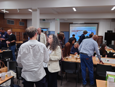 Delegates gather at the Social and Cultural Geography Research Group's 50th anniversary celebration. They are socialising, drinking tea and participating in workshops.