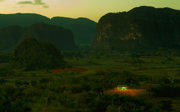 Landscape of a lush, mountainous region with a small traditional cabin in the front.