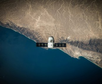 A space satellite above a coastline