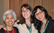 Three people wearing landyards smiling for picture at book awards. Laura Pulido is on the left.