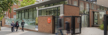 People passing the entrance of the Royal Geographical Society on Exhibition Road.