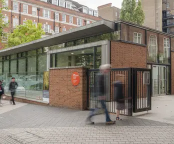 People passing the entrance of the Royal Geographical Society on Exhibition Road.