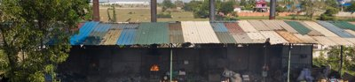Image of small shacks burning rubbish in Cambodia