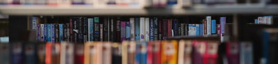 Colourful library books on a shelves.