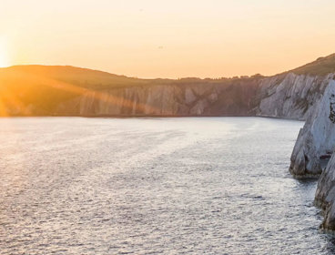 Chalk cliffs and a sea at sunset. 