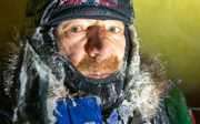 Close-up of Børge Ousland in winter gear with frost and snow stuck on their clothes.