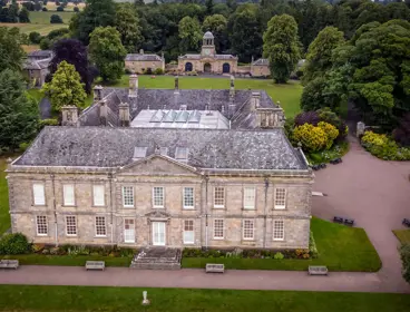 Stately old country house in the middle of the countryside and at the edge of a forest. 