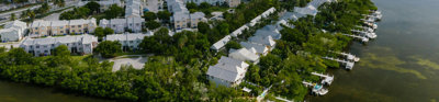 White houses on green reclaimed land near a water course