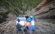 Phoebe Smith photographed from above as they are portaledging off a steep cliff.