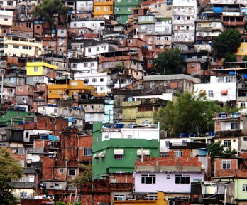 An informal settlement located on a hillside, with many homes squashed together with what looks like no space between them at all