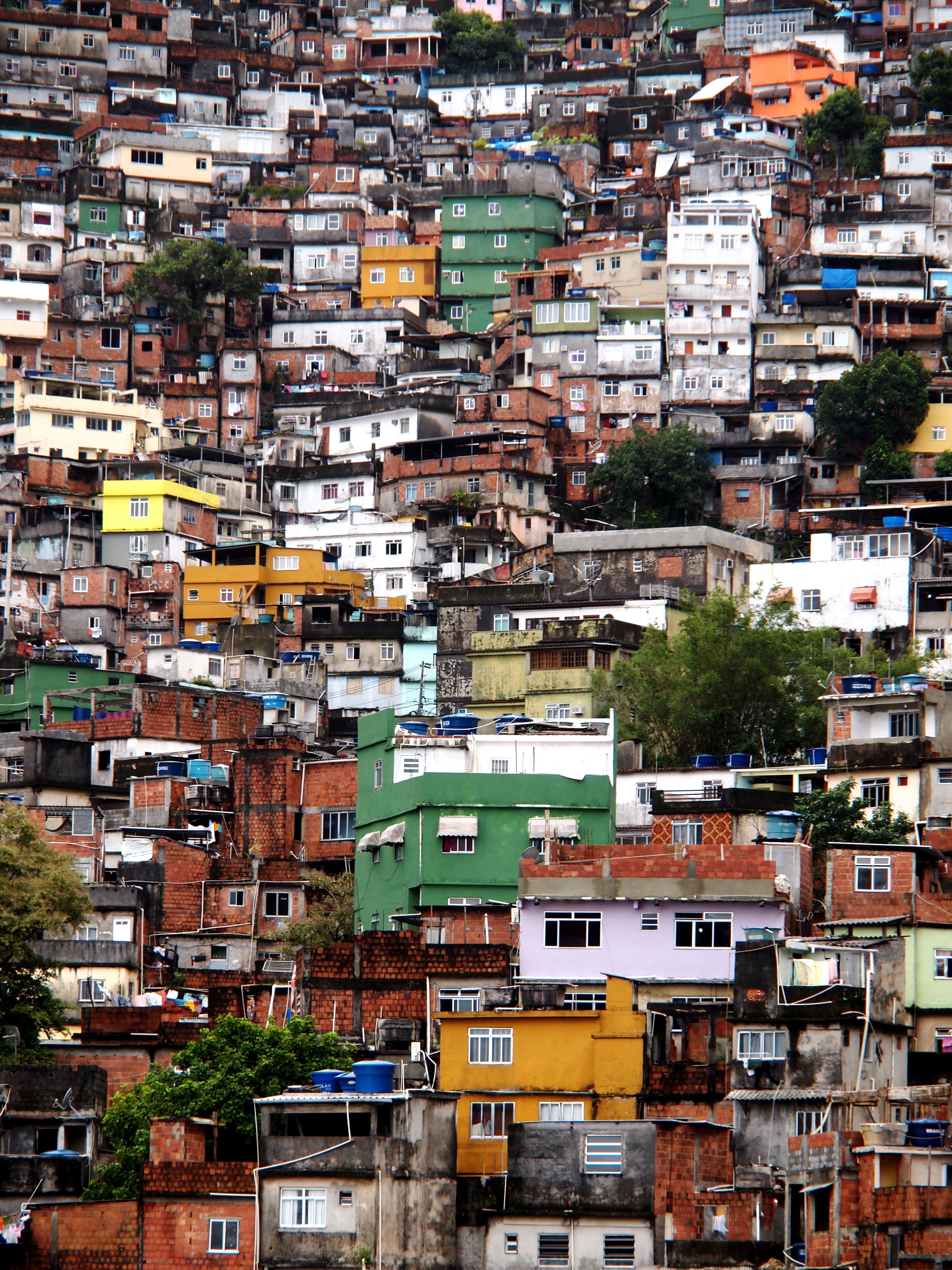 An informal settlement located on a hillside, with many homes squashed together with what looks like no space between them at all