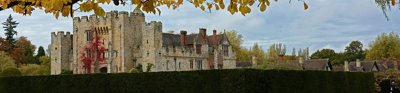 Hever Castle with a moat in front of it in autumn.