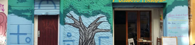 Shop front painted with a tree mural in North Africa