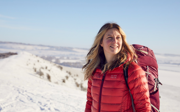 Phoebe Smith on snowy mountain on a sunny, cloudless day.