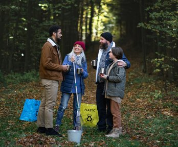 A group of volunteers clearing rubbish in a forest