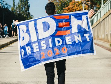 Man holding a Biden banner