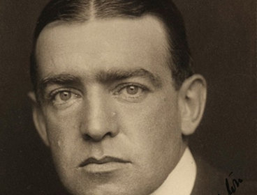 Ernest Shackleton is looking directly at camera, wearing a suit, his hair is parted