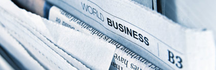 A selection of bunched up newspapers, the prominent one reads 'World Business'