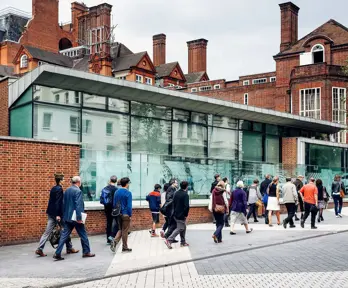 Outside view of the RGS' building with people passing by the RGS pavilion on Exhibition Road.