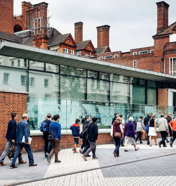 Outside view of the RGS' building with people passing by the RGS pavilion on Exhibition Road.